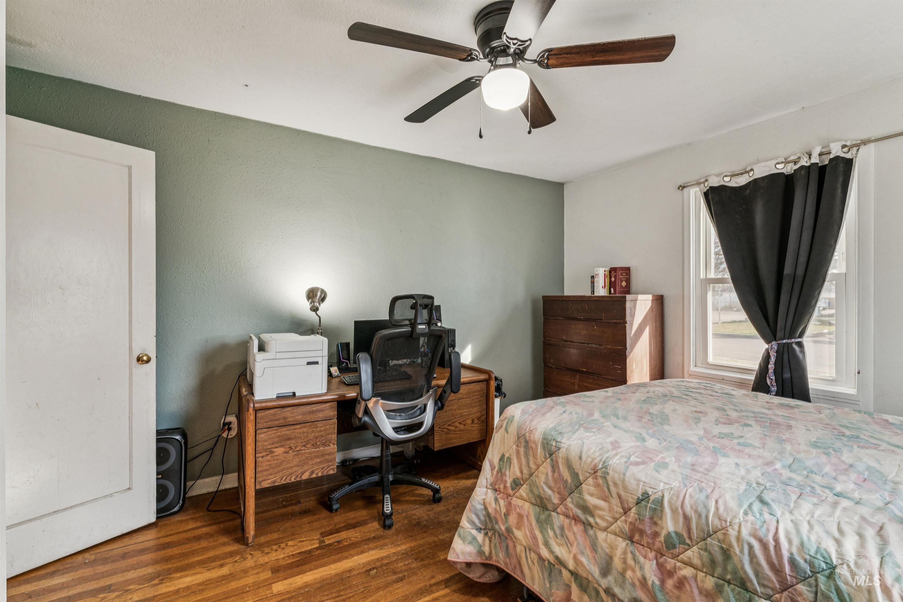 124 Halstead Street Caldwell, ID 83605 - Photo 9 of 42 Bedroom featuring dark wood-style flooring, an office area, and ceiling fan