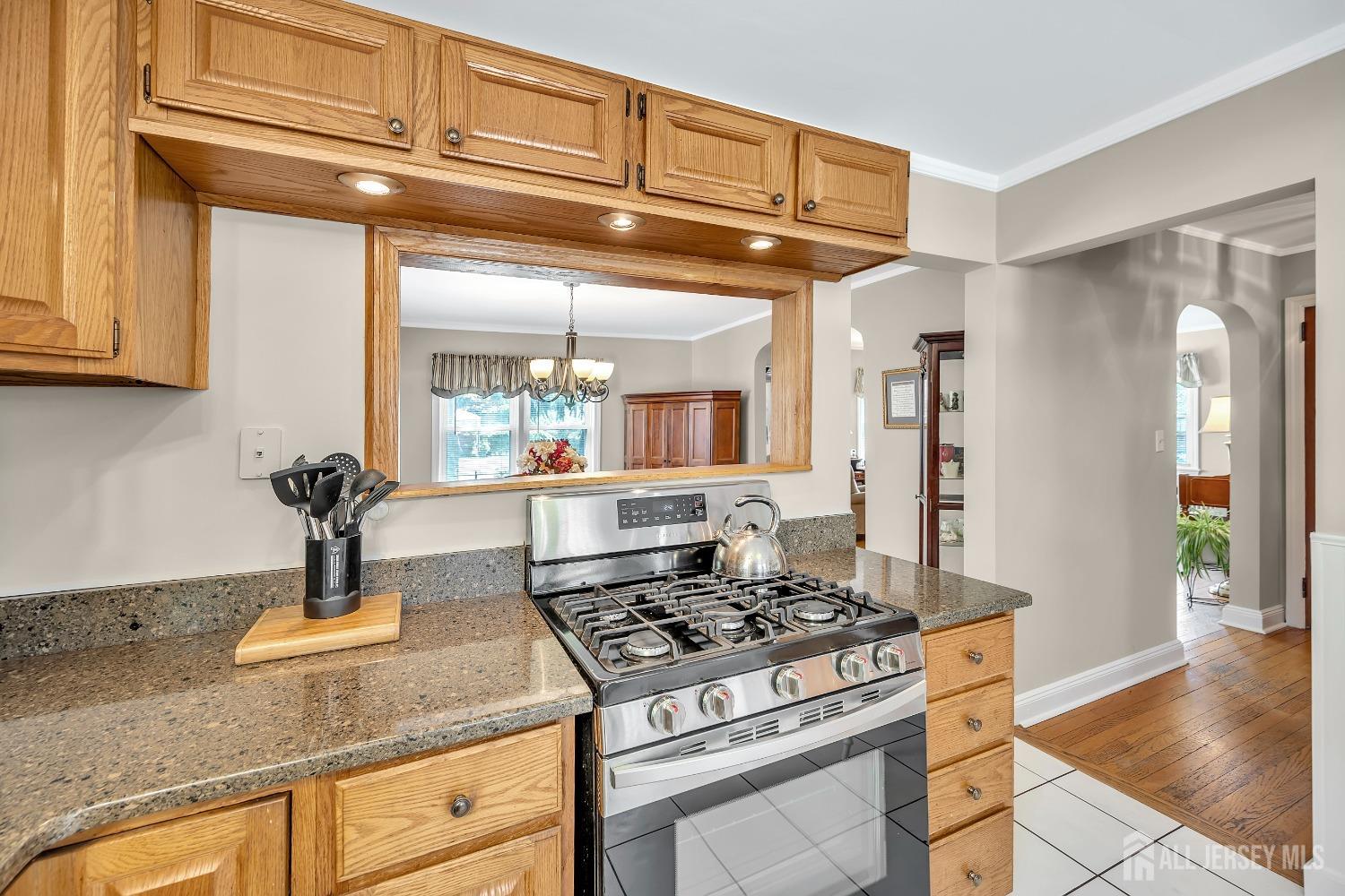 446 2nd Street Dunellen, NJ 08812 - Photo 15 of 31 a kitchen with stainless steel appliances granite countertop a stove and a refrigerator