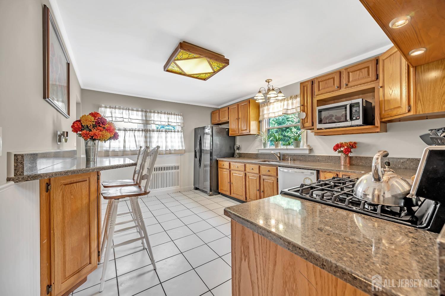 446 2nd Street Dunellen, NJ 08812 - Photo 16 of 31 a kitchen with stainless steel appliances granite countertop a sink and cabinets