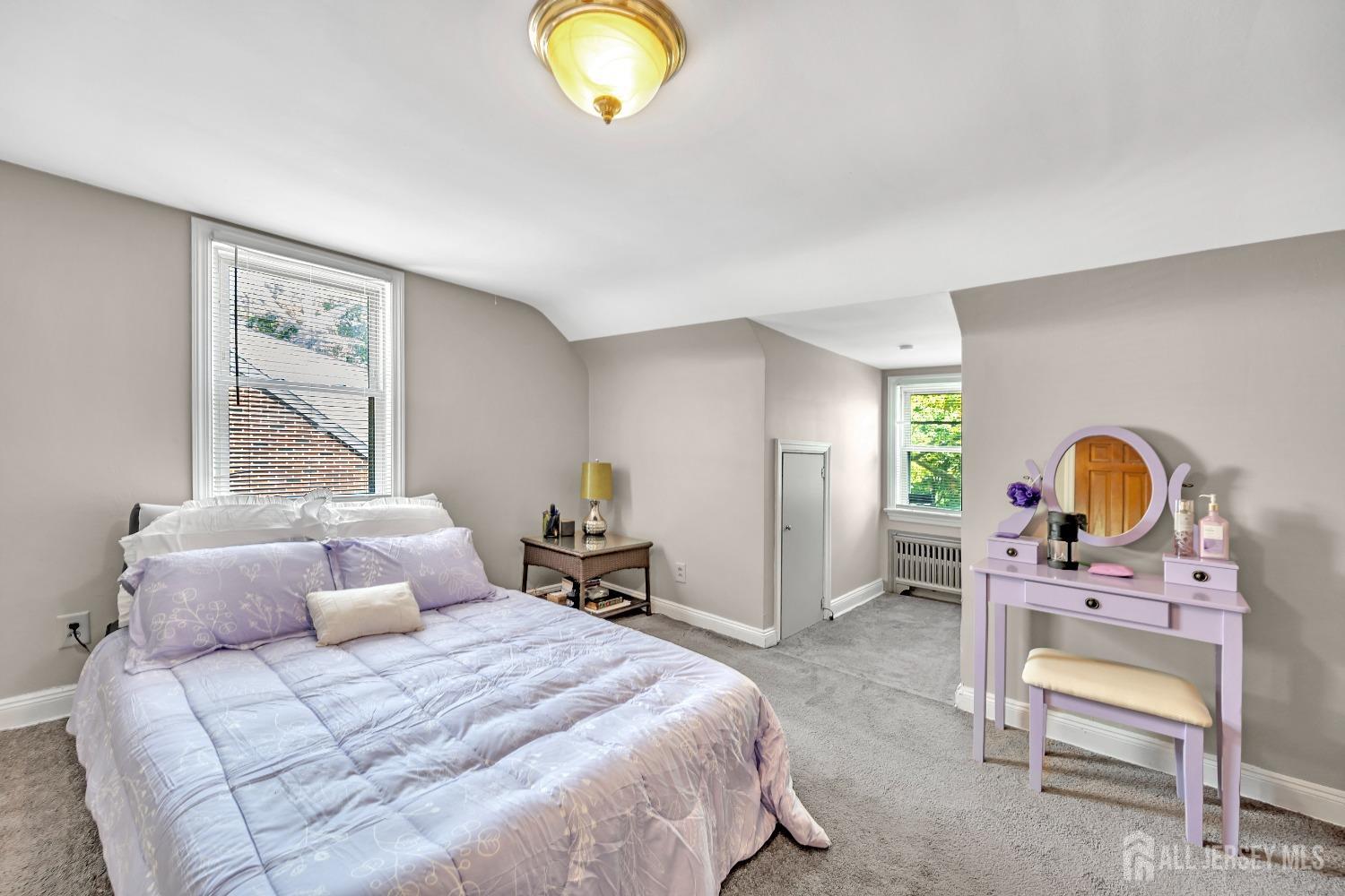 446 2nd Street Dunellen, NJ 08812 - Photo 22 of 31 a bedroom with a bed a table and a chair