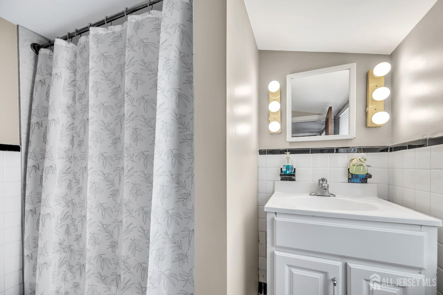 446 2nd Street Dunellen, NJ 08812 - Photo 23 of 31 a bathroom with a sink and a mirror