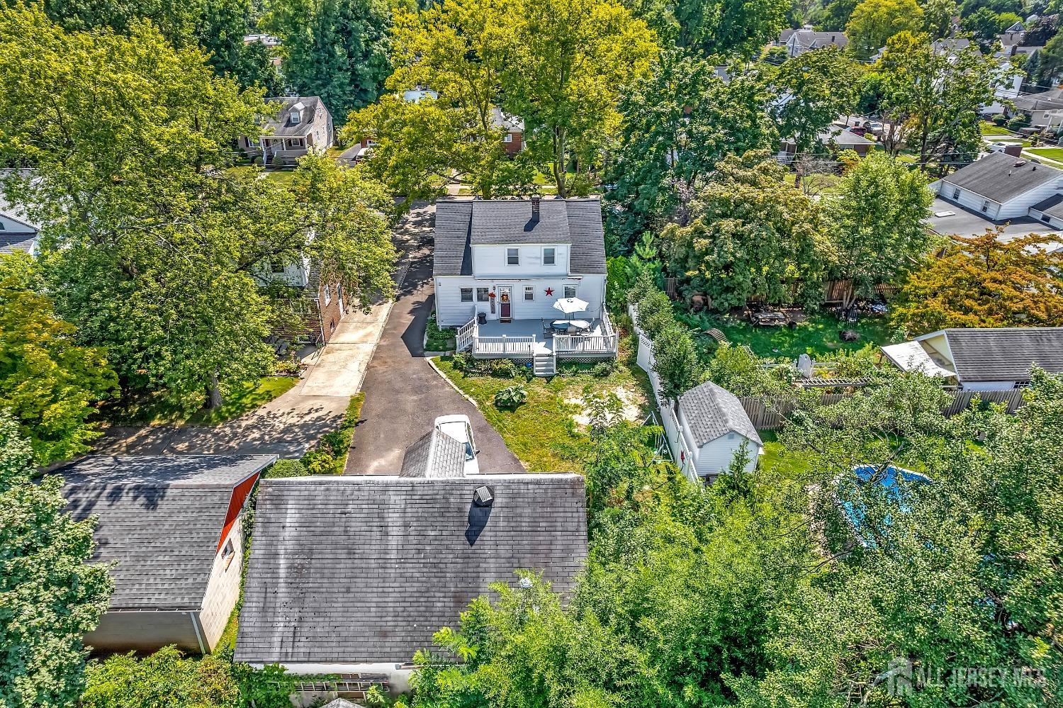 446 2nd Street Dunellen, NJ 08812 - Photo 27 of 31 an aerial view of a house with a garden and trees