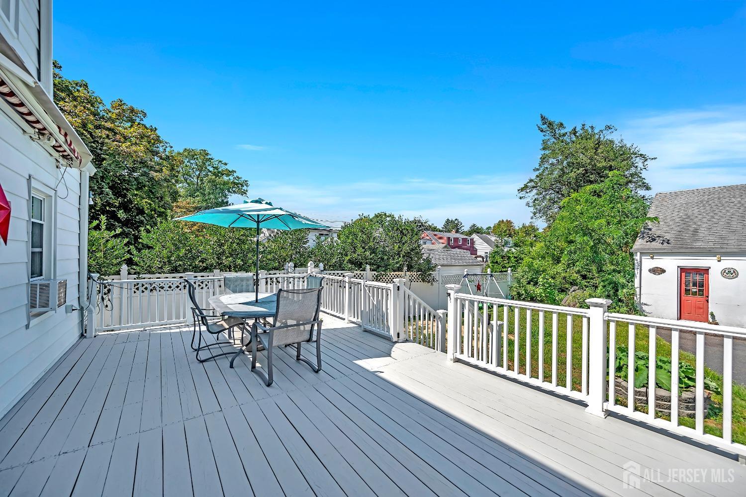 446 2nd Street Dunellen, NJ 08812 - Photo 31 of 31 a view of a roof deck with table and chairs with wooden floor and fence
