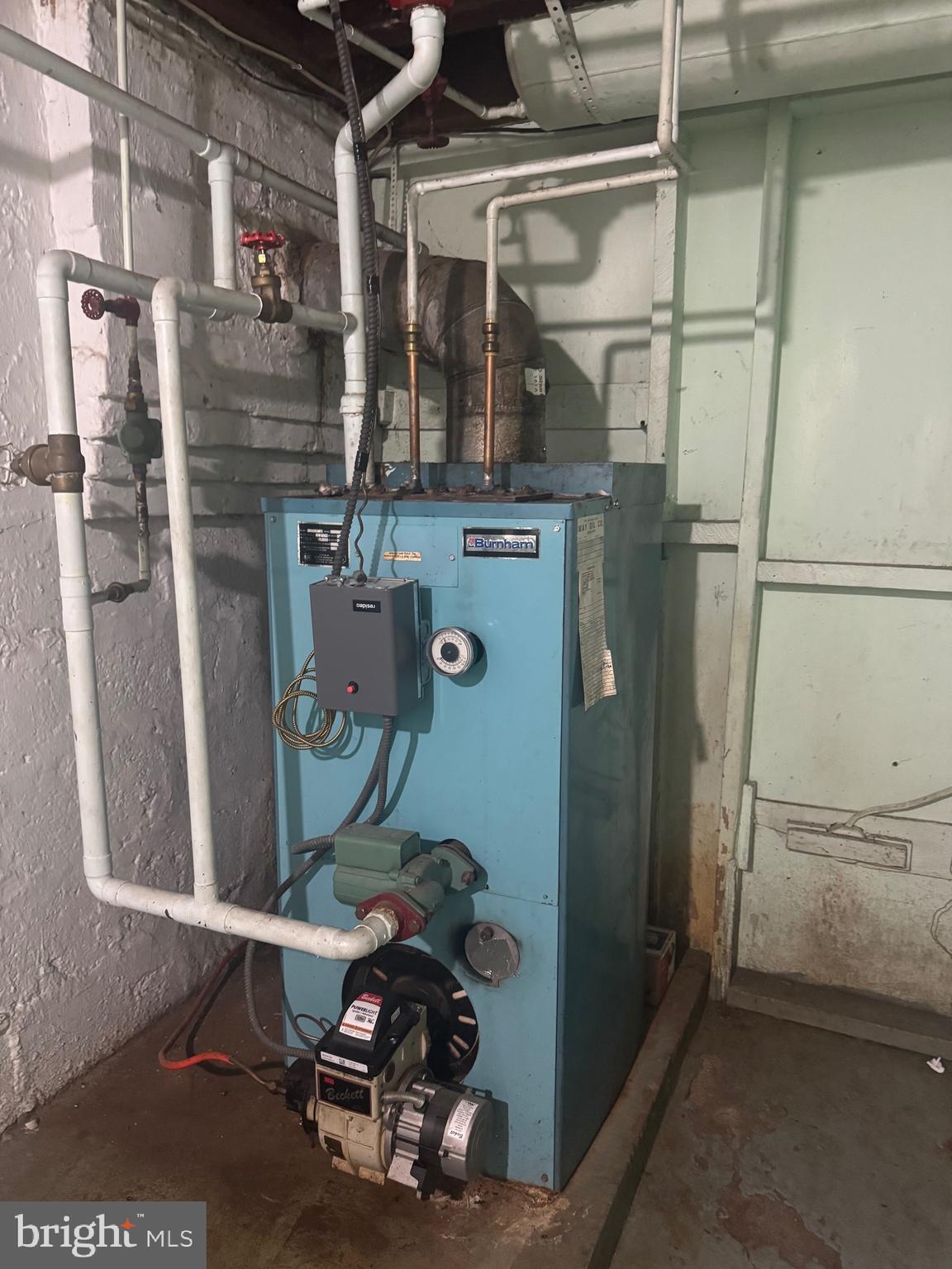 519 3rd Street Lancaster, PA 17603 - Photo 11 of 13 a room with water heater and wooden cabinets