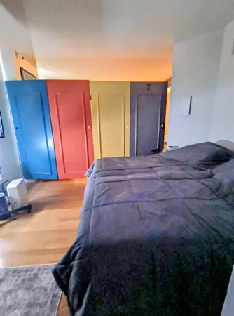 a bedroom with a bed and a dresser