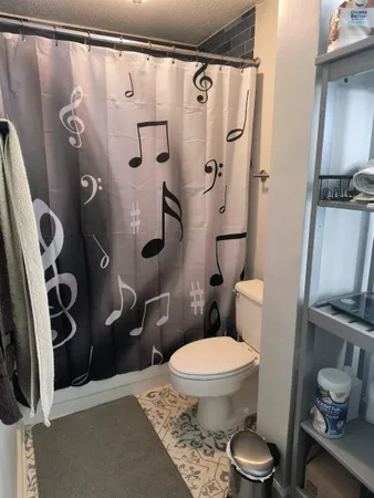 a bathroom with a toilet and a shower