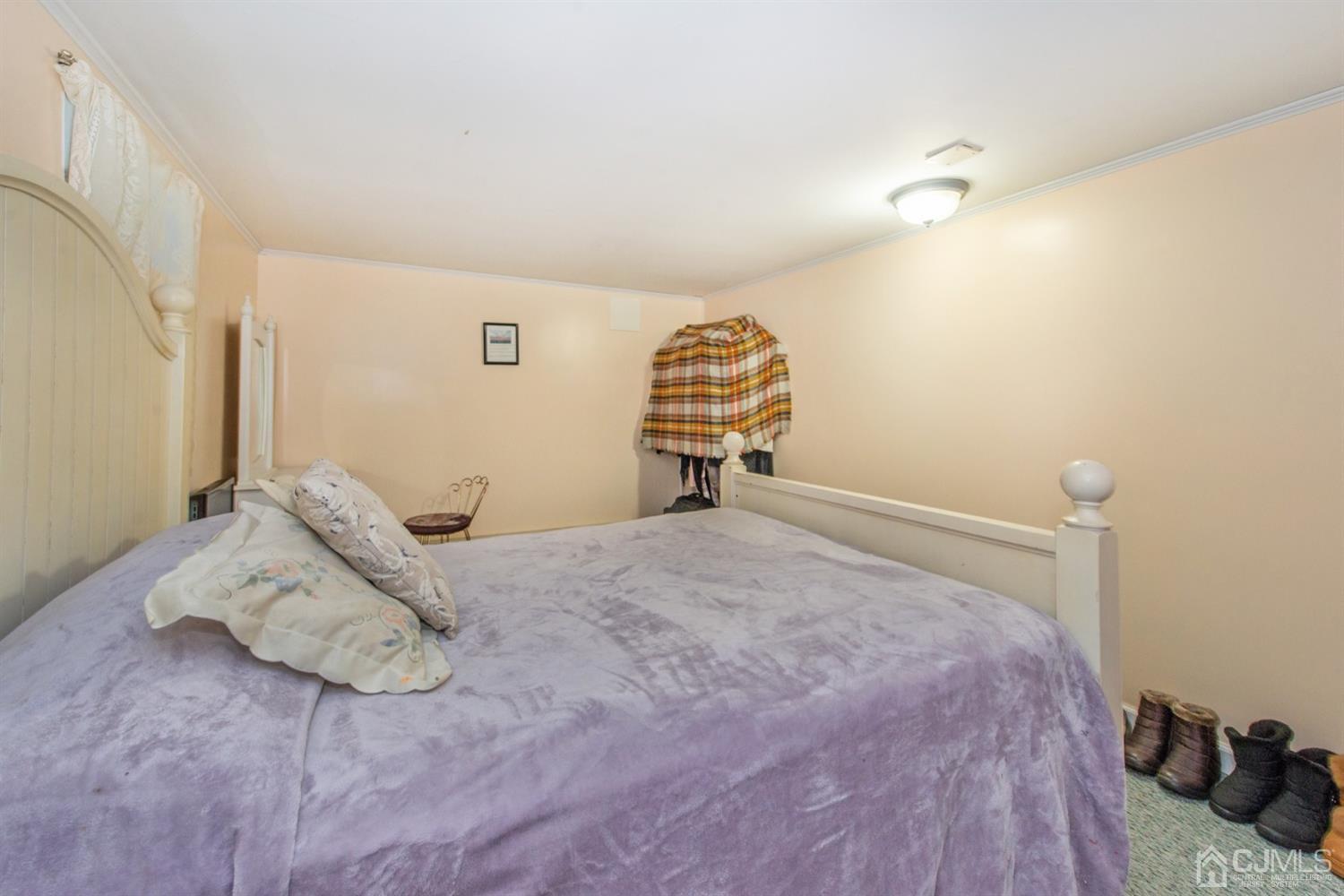 104 Highfield Road Colonia, NJ 07067 - Photo 22 of 23 a bedroom with a bed and wooden floor