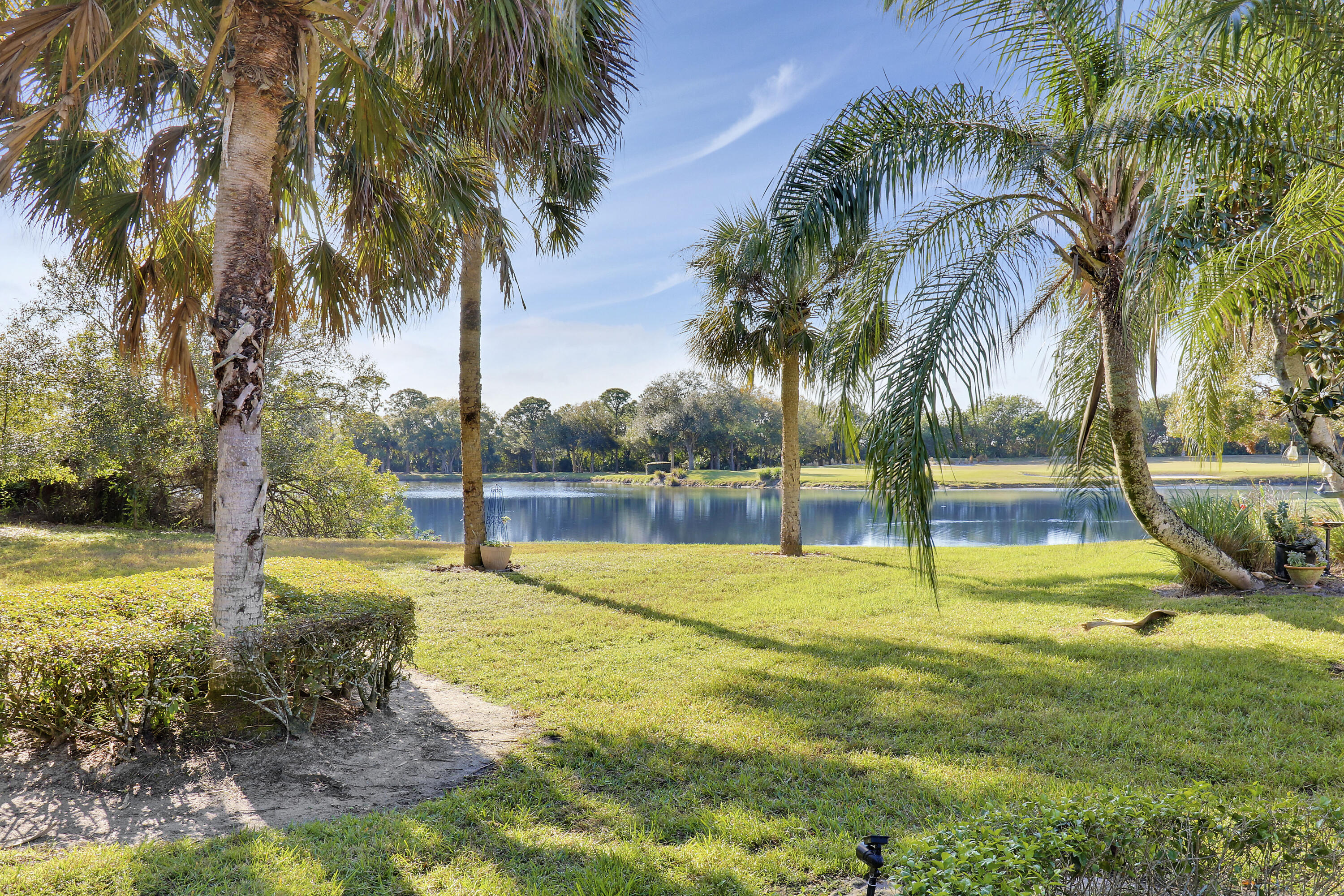 918 Southwest Balmoral Trace Stuart, FL 34997 - Photo 18 of 20 a swimming pool with lots of palm trees