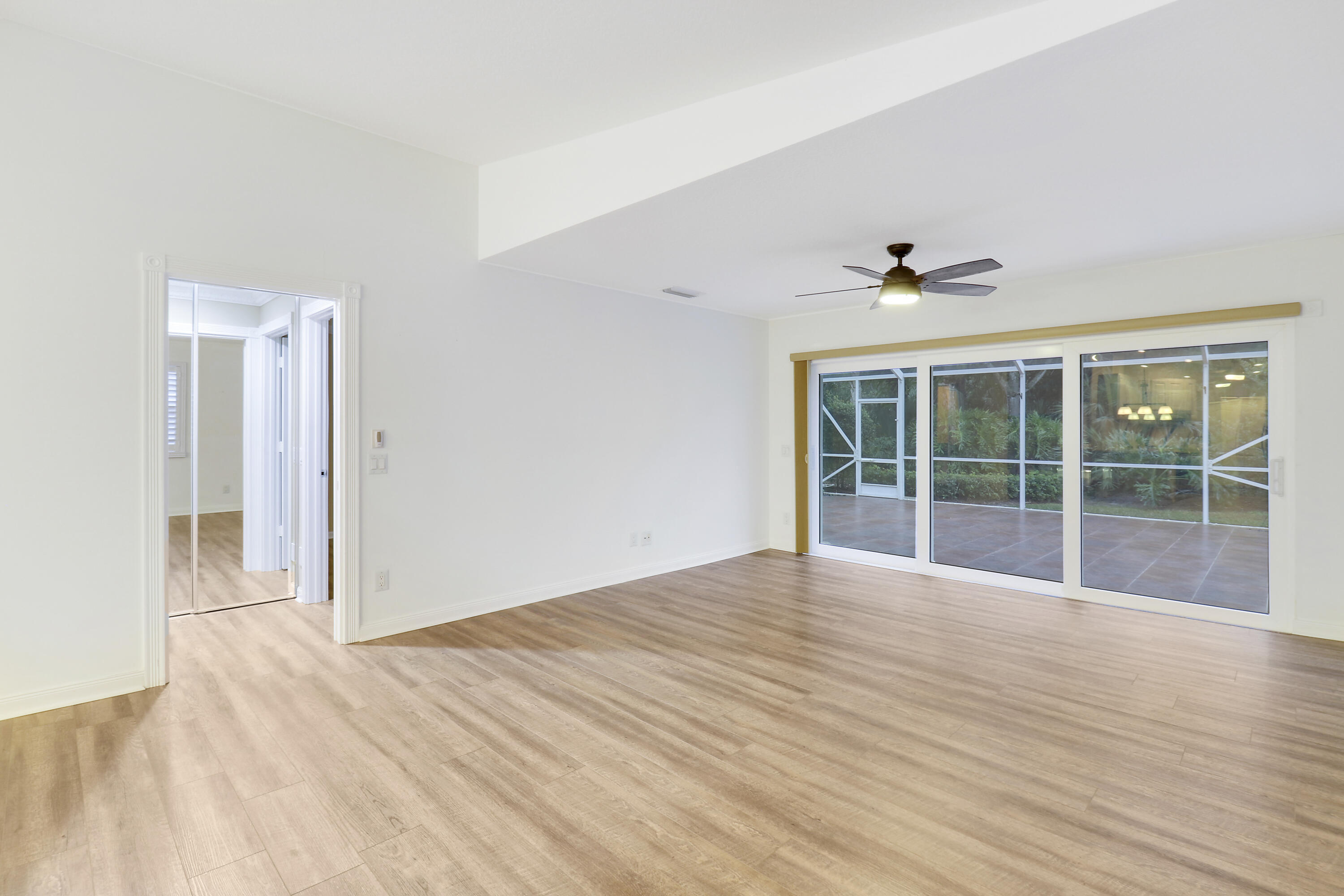 918 Southwest Balmoral Trace Stuart, FL 34997 - Photo 4 of 20 a view of an empty room with a window and wooden floor