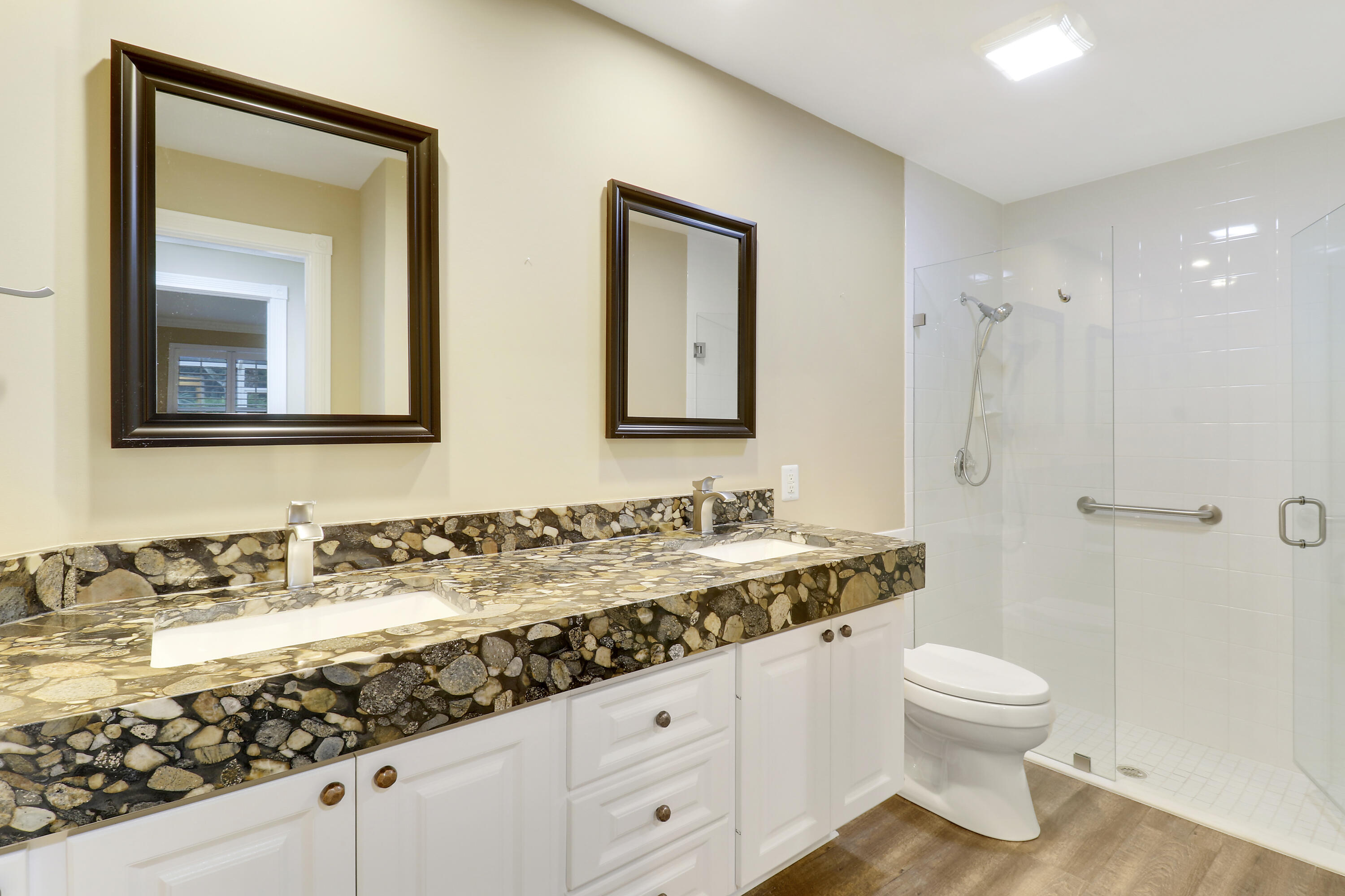 918 Southwest Balmoral Trace Stuart, FL 34997 - Photo 7 of 20 a bathroom with a granite countertop sink a toilet and a mirror