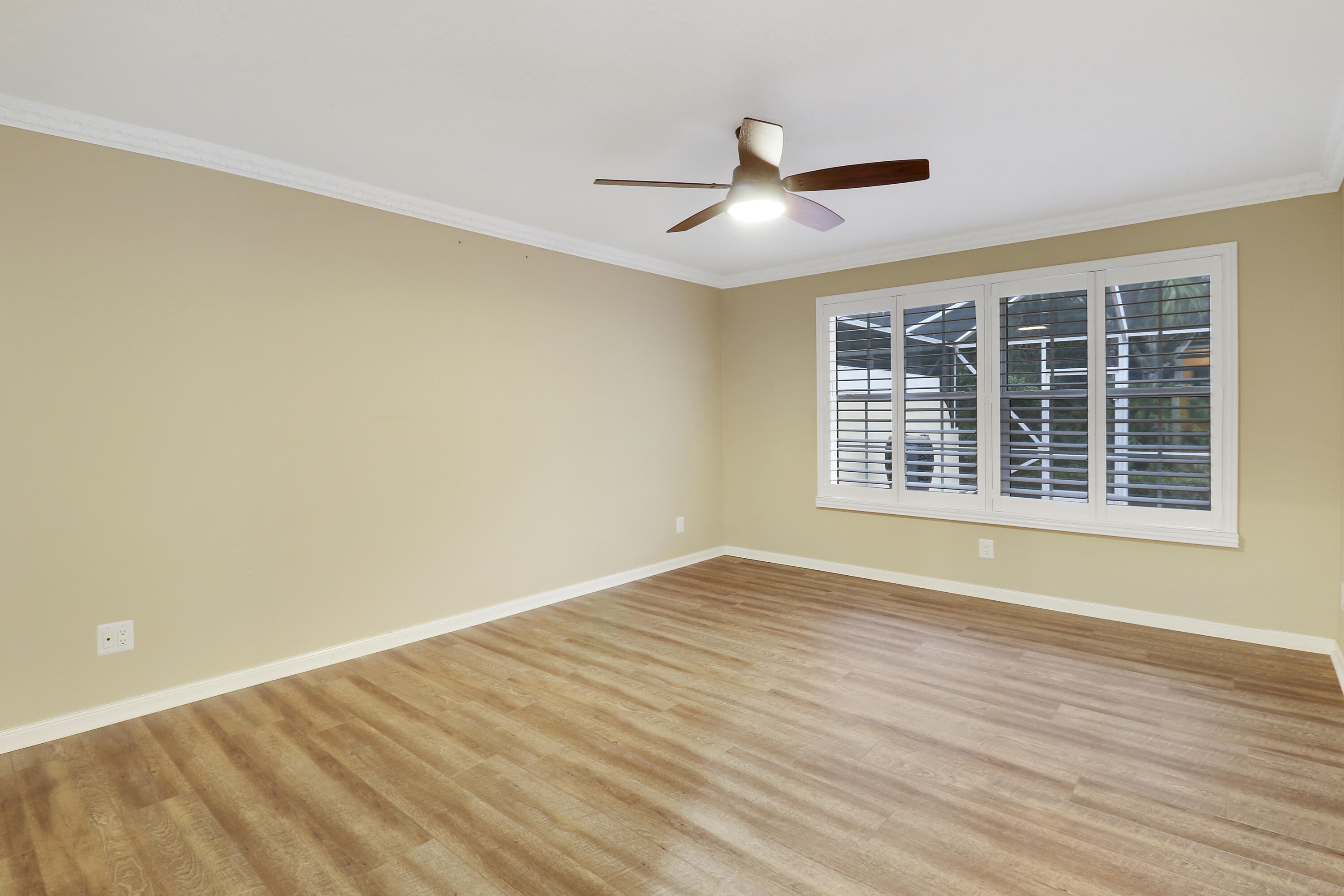 918 Southwest Balmoral Trace Stuart, FL 34997 - Photo 8 of 20 a view of an empty room with wooden floor and a window