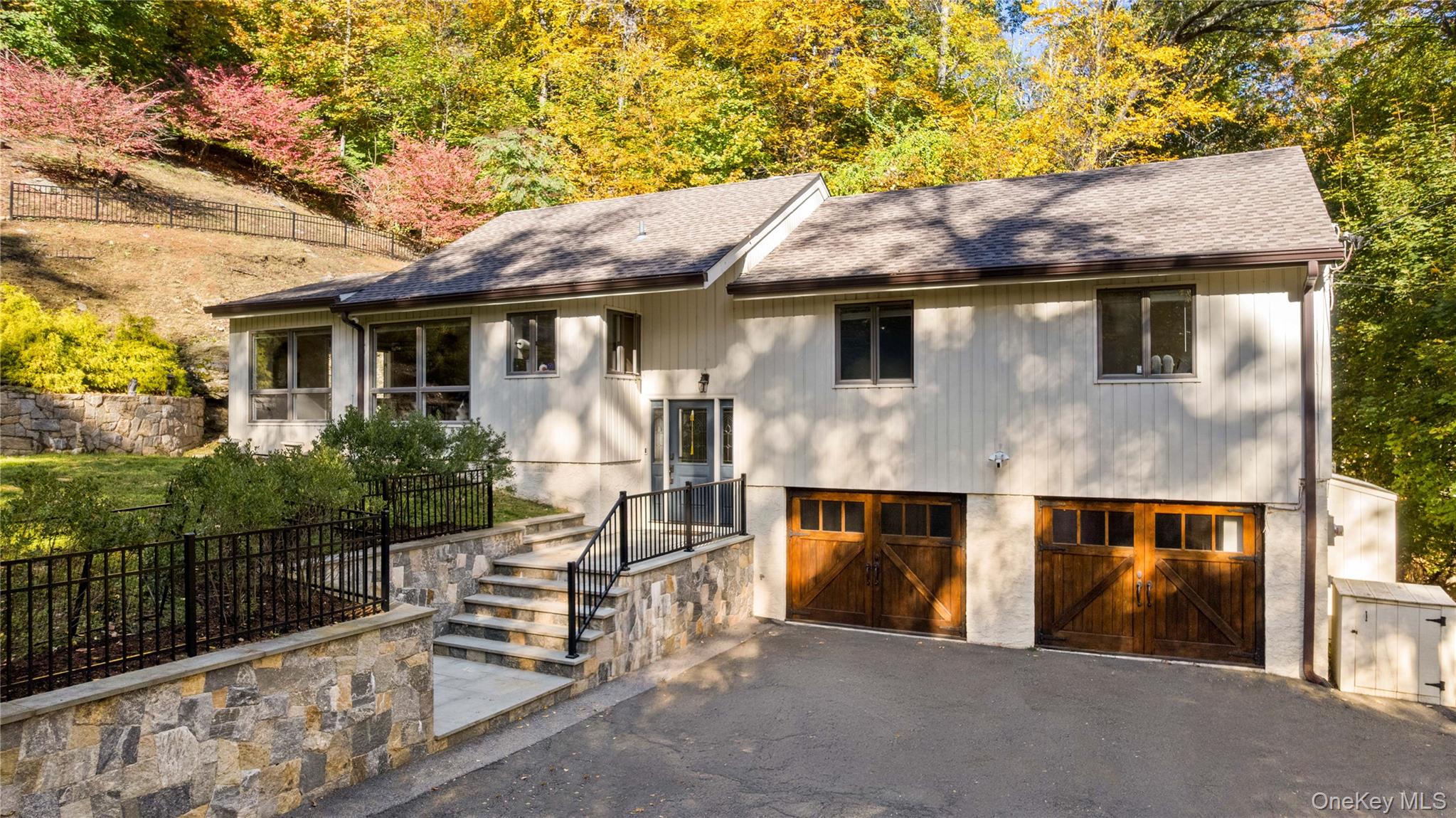 16 Highclere Lane, Unit A Valhalla, NY 10595 - Photo 1 of 1 a view of a white house with large windows and a small yard