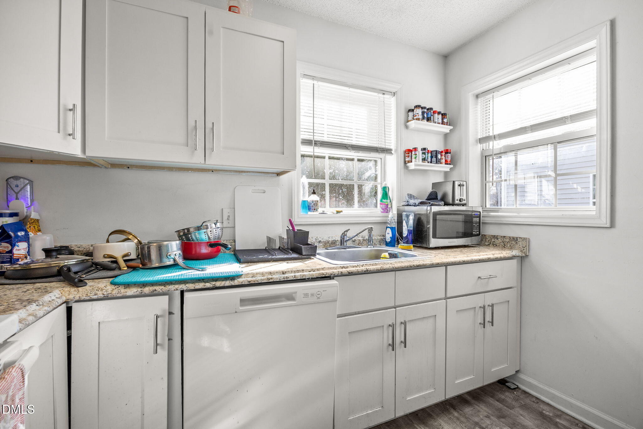 1305 Kent Road, Unit 101 Raleigh, NC 27606 - Photo 9 of 29 a kitchen with white cabinets white appliances and sink
