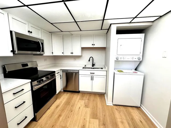 a kitchen with a stove a sink and a microwave