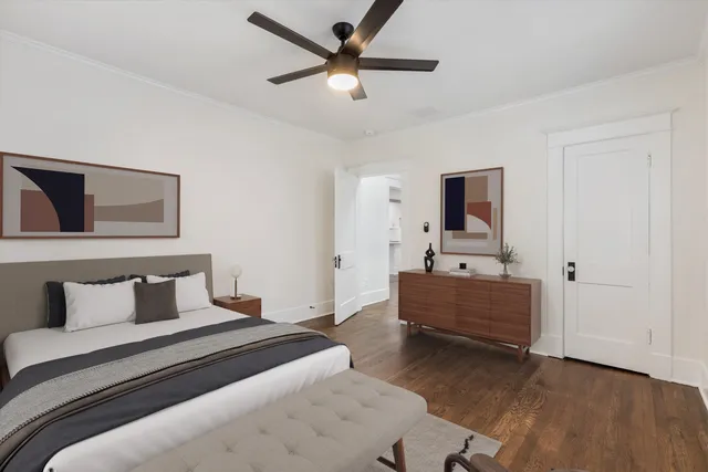 an empty room with wooden floor and a ceiling fan