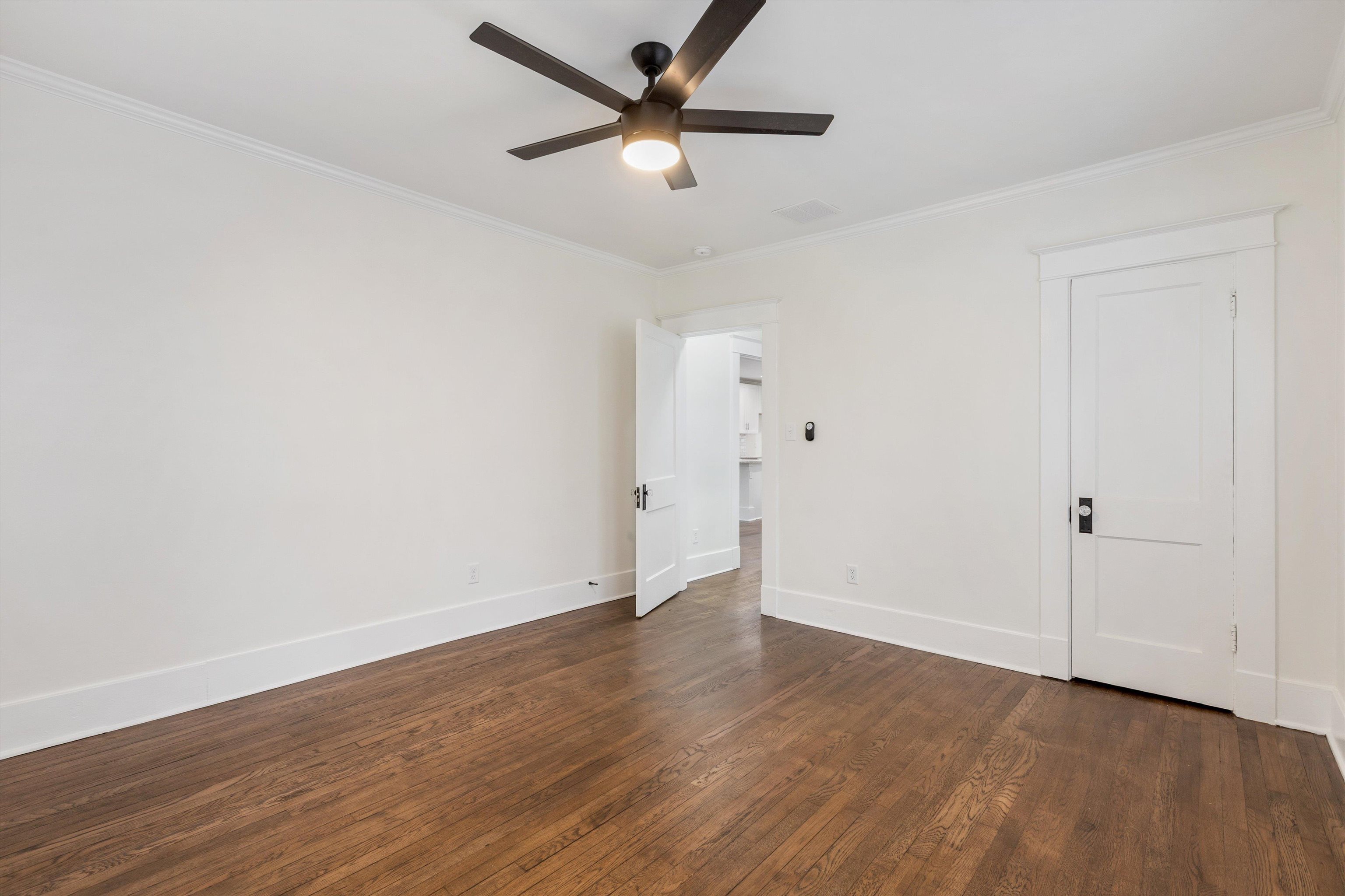 176 Plainview Street Memphis, TN 38111 - Photo 24 of 40 an empty room with wooden floor and a ceiling fan