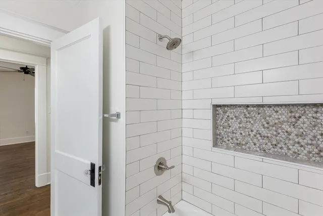 a living room with furniture and a view of kitchen