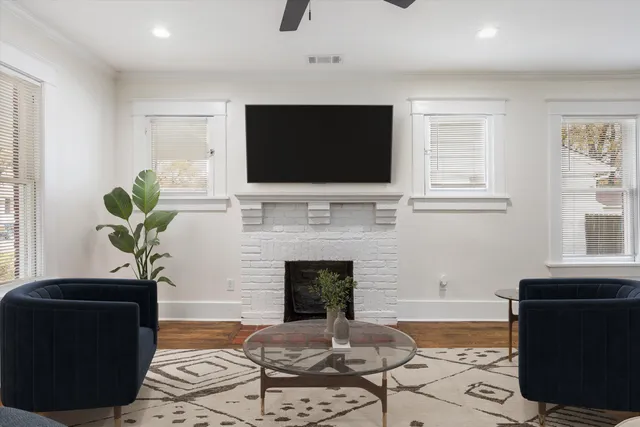 a view of empty room with wooden floor and fireplace
