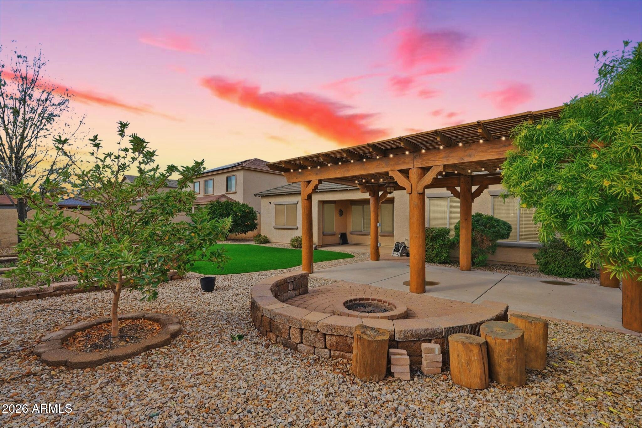 a view of a house with backyard and sitting area