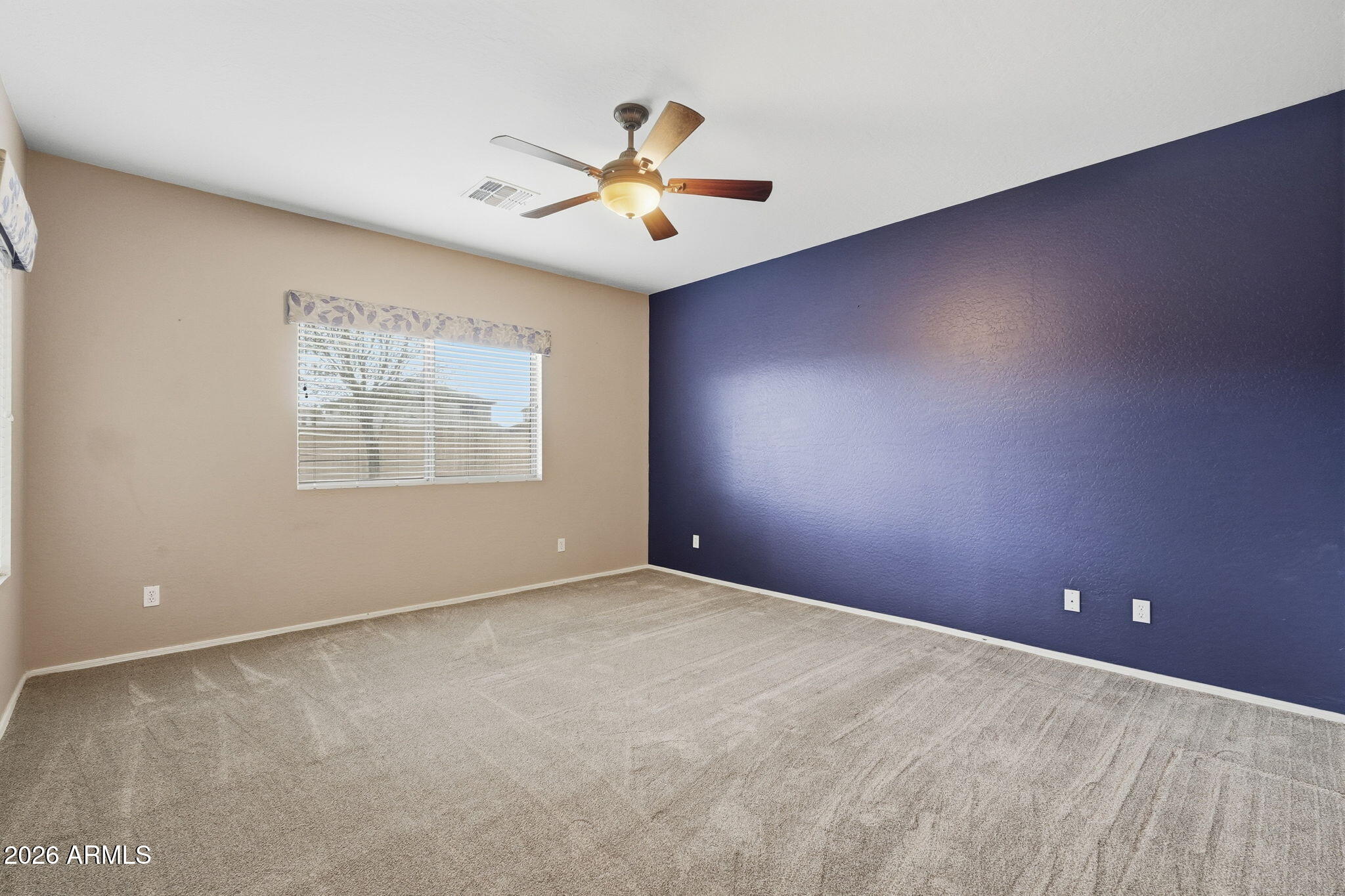 9917 Barley Road Florence, AZ 85132 - Photo 22 of 53 an empty room with chandelier fan and windows