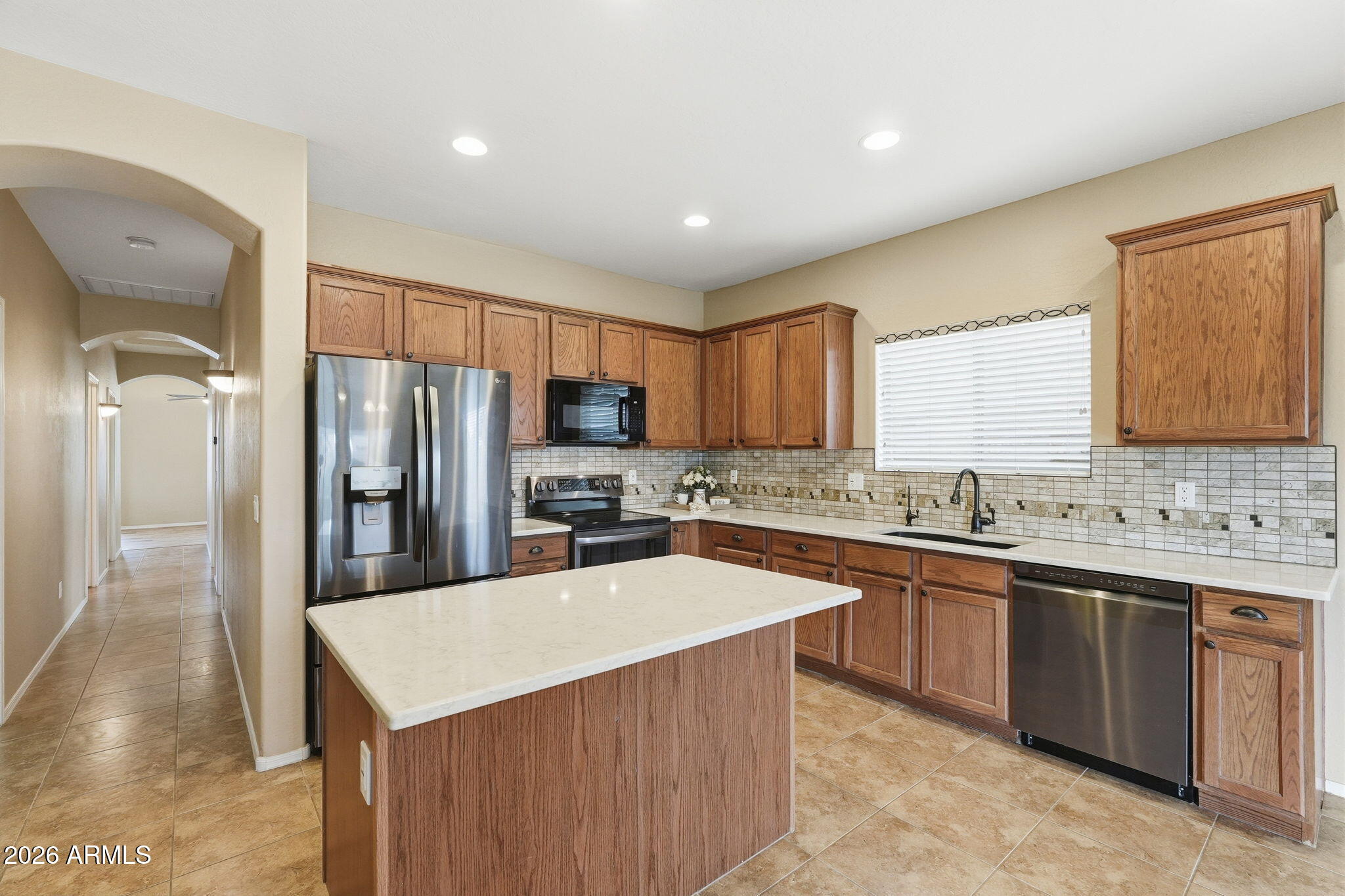 9917 Barley Road Florence, AZ 85132 - Photo 4 of 53 a kitchen with stainless steel appliances a sink stove refrigerator and cabinets