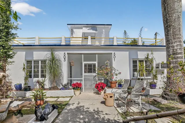 a building outdoor space with patio furniture and potted plants