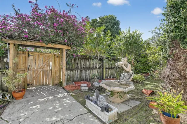 a view of a porch with chairs and potted plants