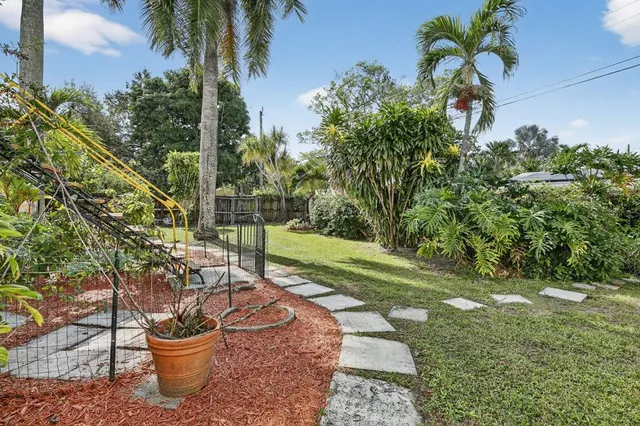 a view of a chairs and table in backyard