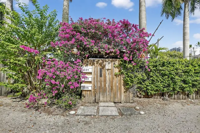 a front view of a house with a flower garden