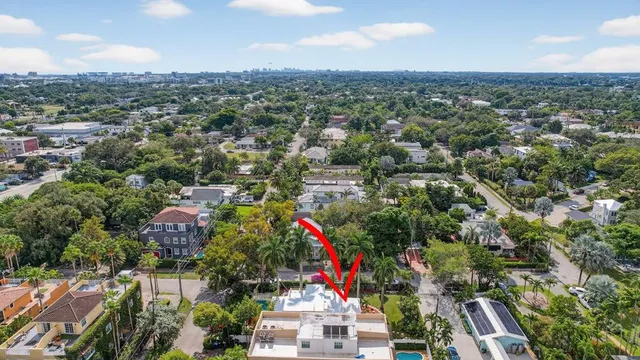 an aerial view of a house with a yard and garden