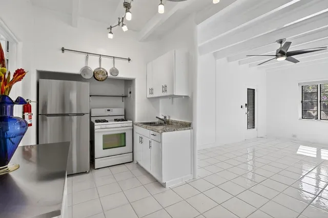 a kitchen with cabinets and stainless steel appliances