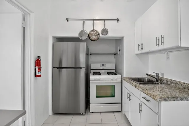 a kitchen with appliances cabinets and a counter top space