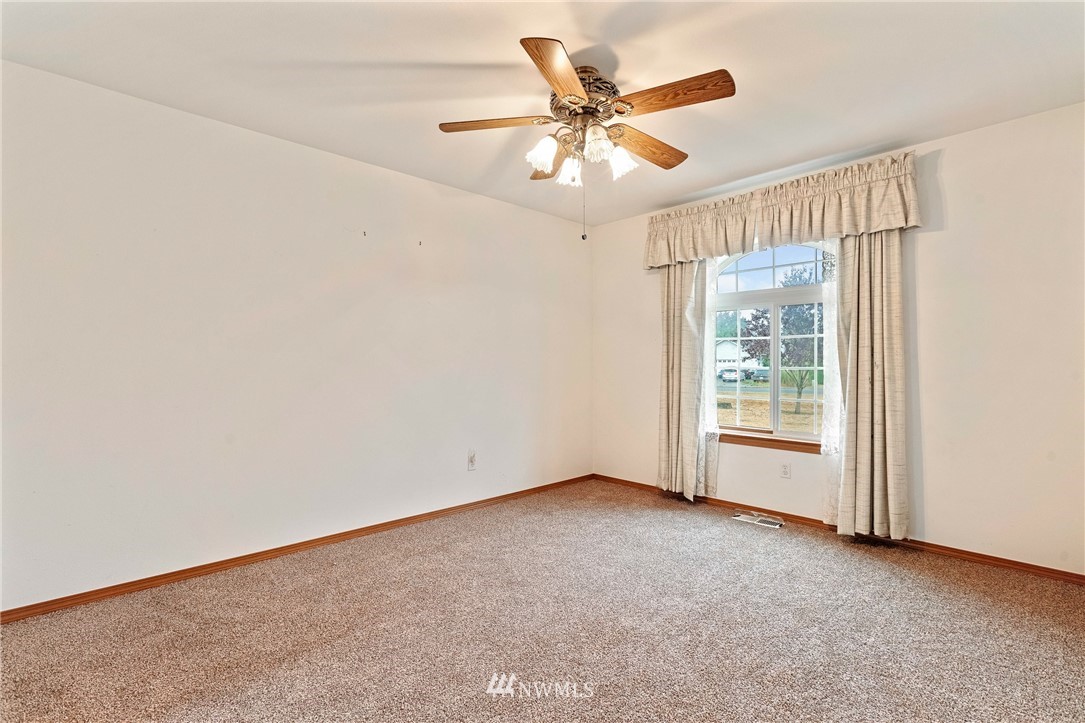 8835 181st Way Southwest Rochester, WA 98579 - Photo 14 of 20 an empty room with windows and fan