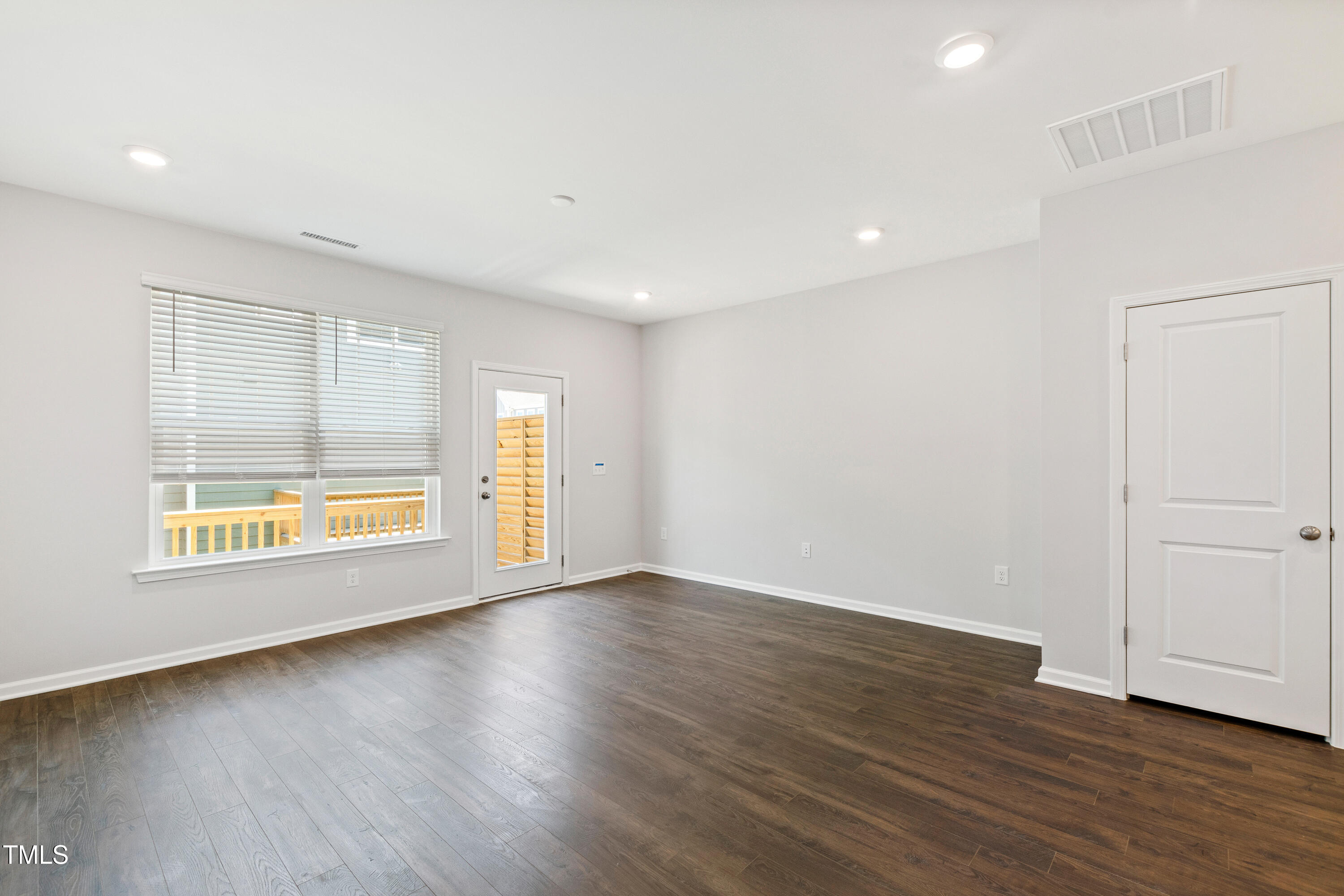 1102 Harmony Trail Durham, NC 27703 - Photo 13 of 33 an empty room with wooden floor and windows