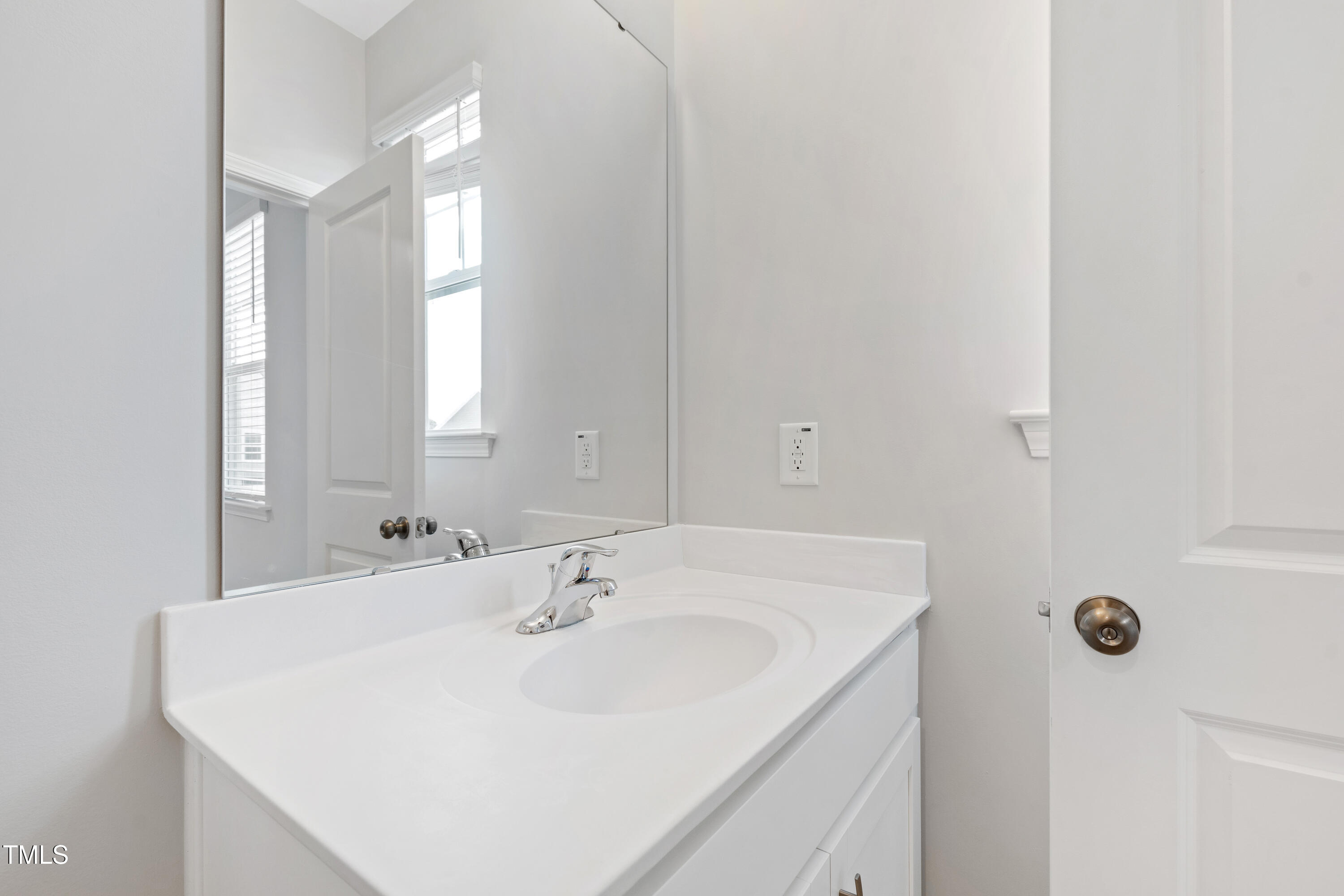 1102 Harmony Trail Durham, NC 27703 - Photo 15 of 33 a bathroom with a sink and a mirror
