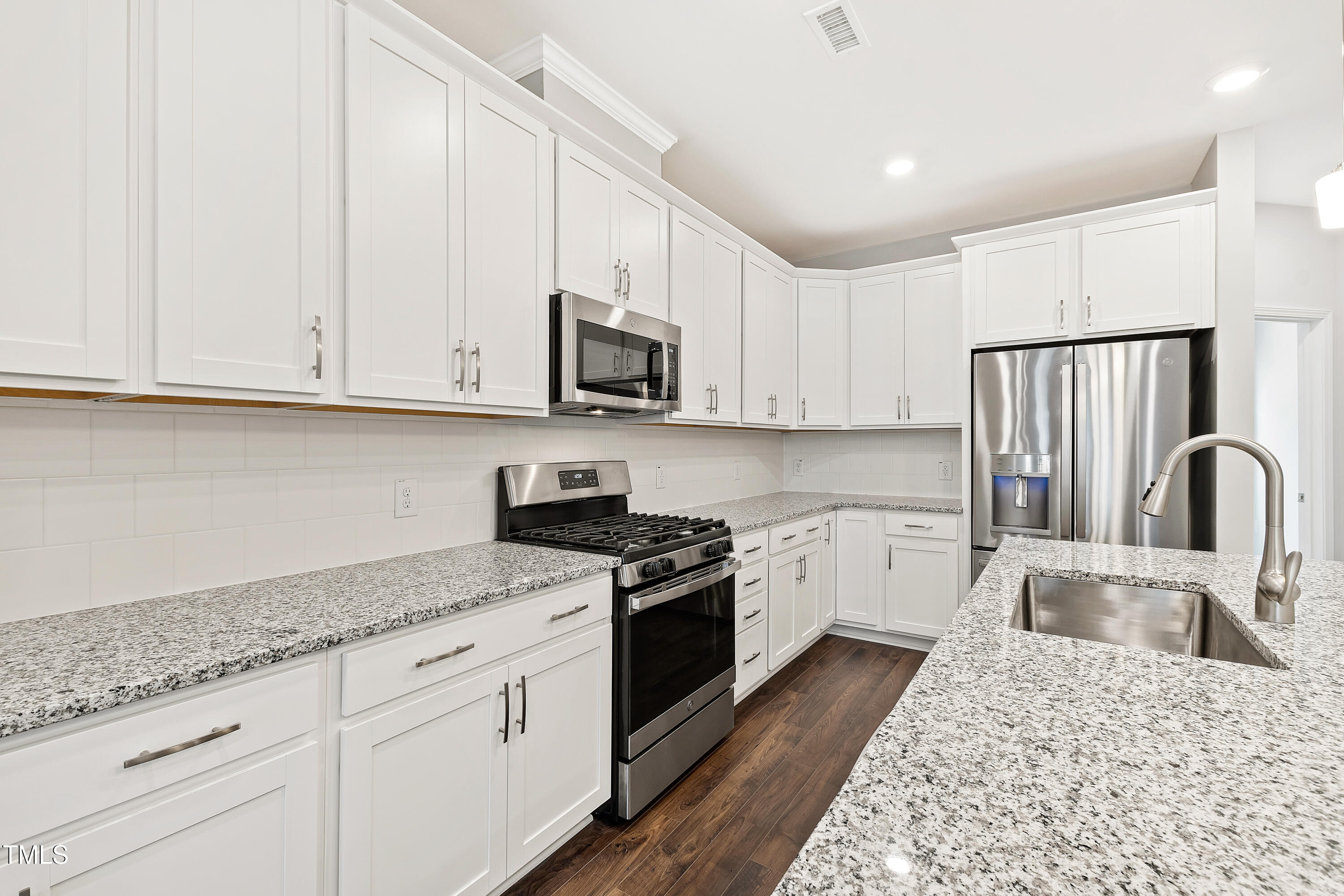 1102 Harmony Trail Durham, NC 27703 - Photo 3 of 33 a kitchen with granite countertop a sink a stove and cabinets
