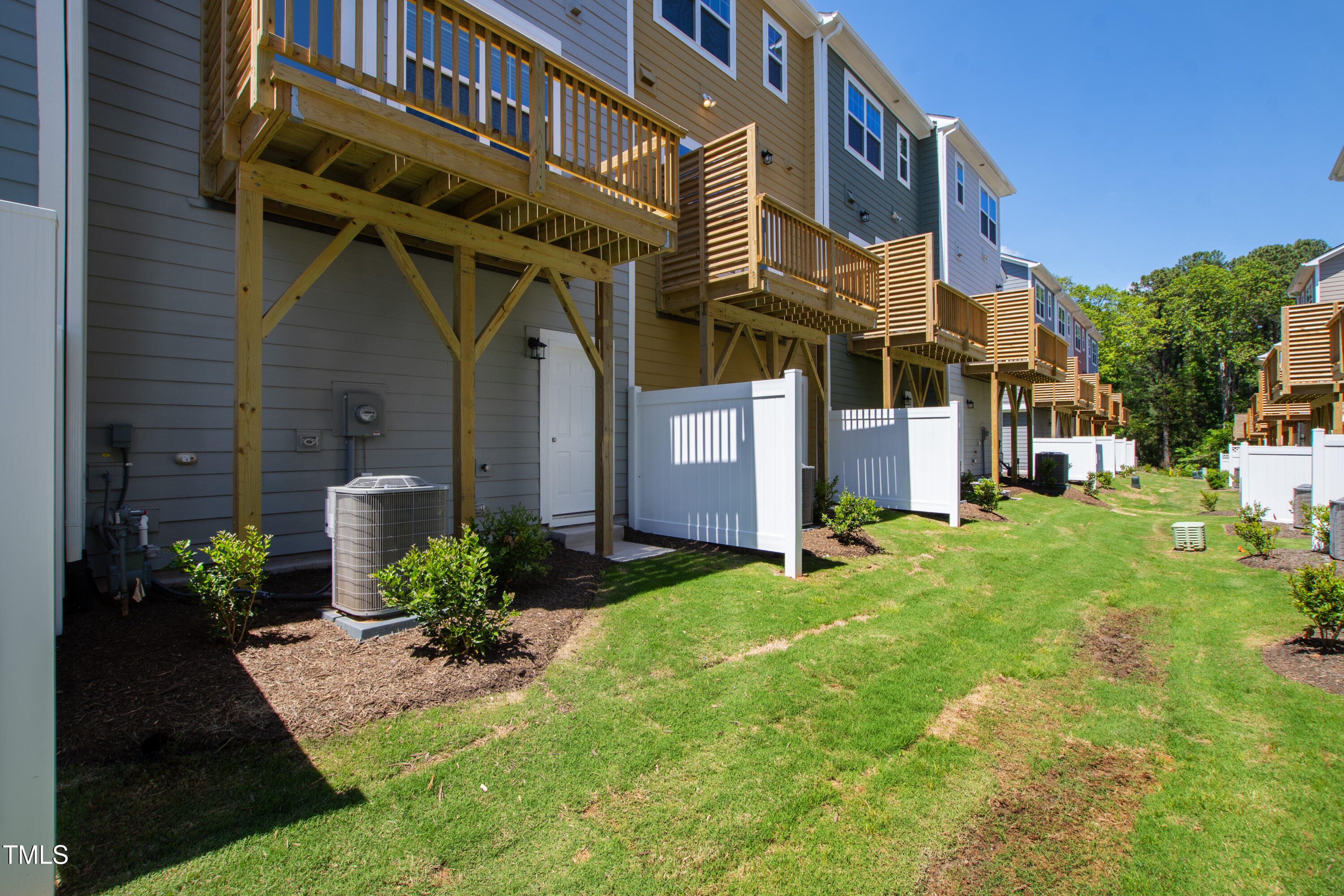 1102 Harmony Trail Durham, NC 27703 - Photo 31 of 33 a view of a house with brick walls and a yard with plants