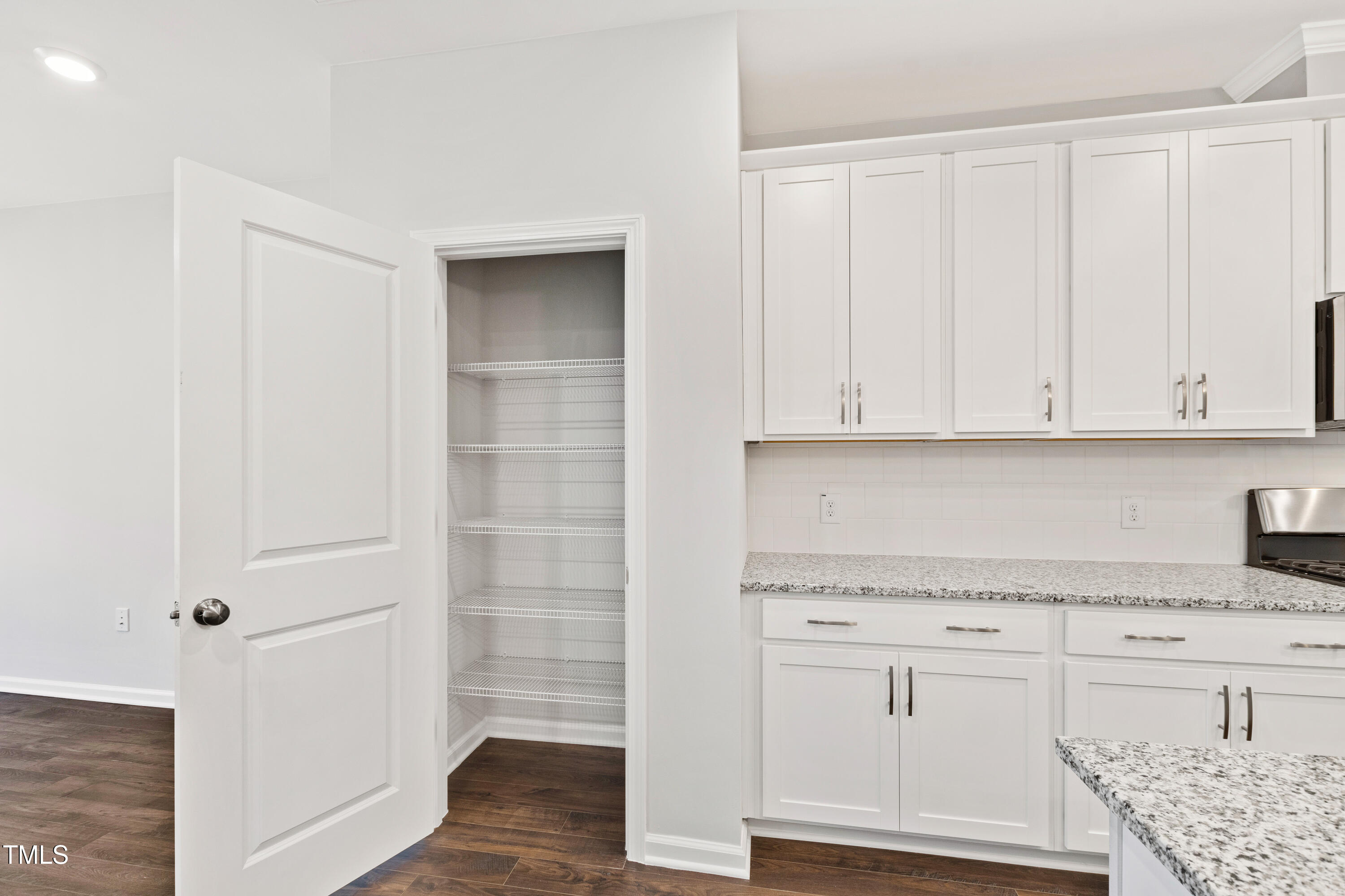 1102 Harmony Trail Durham, NC 27703 - Photo 8 of 33 a kitchen with granite countertop white cabinets and white appliances
