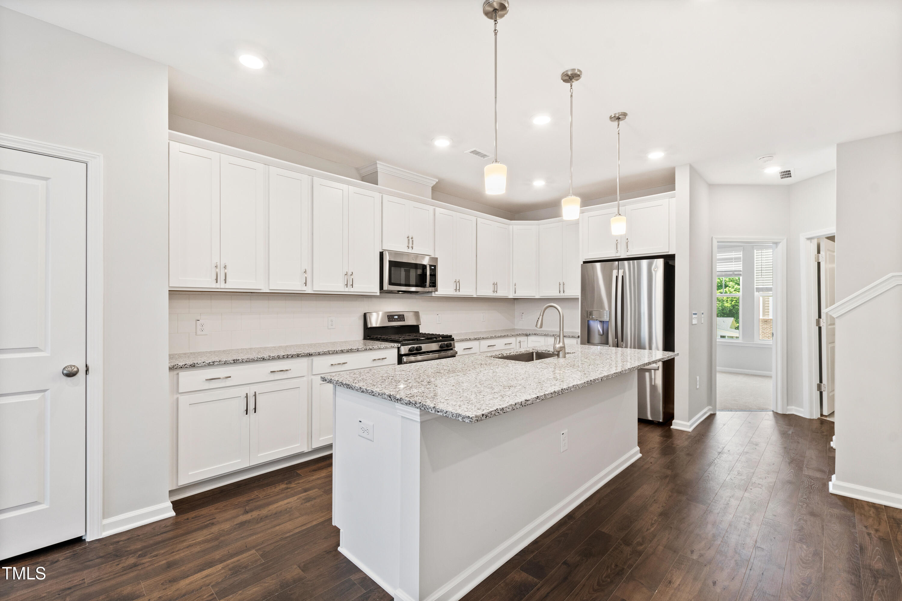 1102 Harmony Trail Durham, NC 27703 - Photo 9 of 33 a kitchen with stainless steel appliances granite countertop a refrigerator a sink dishwasher a stove and white cabinets with wooden floor