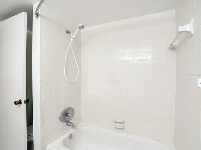 a bathroom with a bath tub with a shower