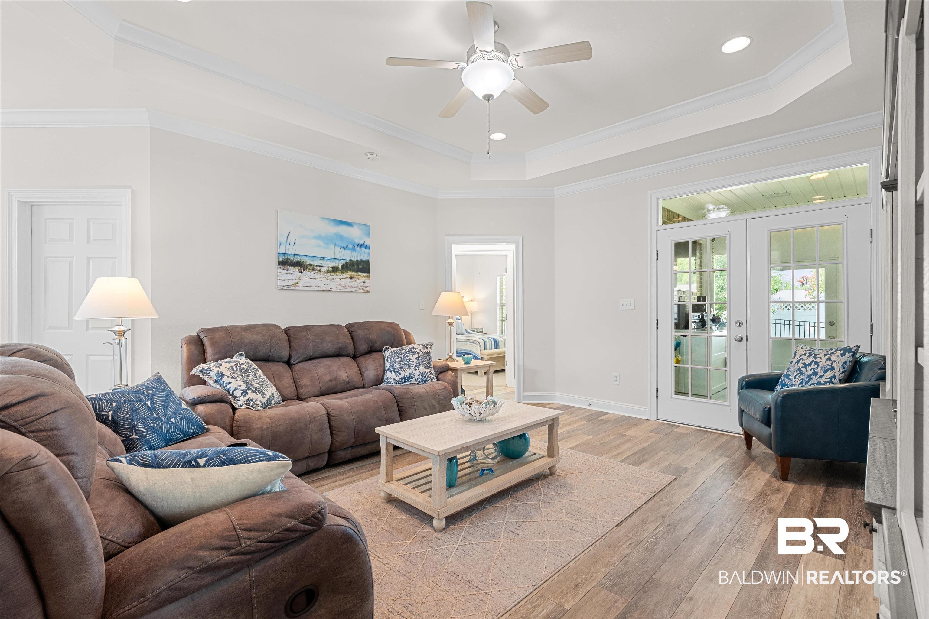 141 Mark Twain Loop Foley, AL 36535 - Photo 11 of 55 Living room featuring a raised ceiling, light wood finished floors, a ceiling fan, recessed lighting, and crown molding
