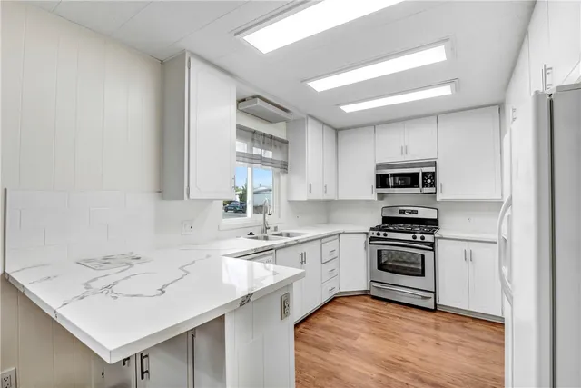 a bathroom with a shower sink vanity and mirror