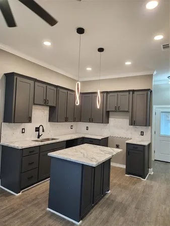 a kitchen with a sink and cabinets