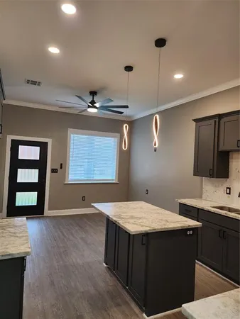 a bathroom with a sink a vanity and a large mirror