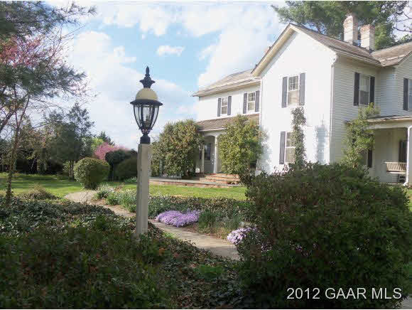 4577 Rockfish Road Grottoes, VA 24441 - Photo 1 of 7 a front view of a house with plants and garden