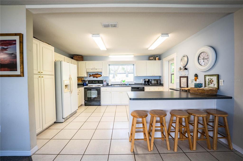 1702 North Scenic Highway Babson Park, FL 33827 - Photo 19 of 46 a kitchen with stainless steel appliances granite countertop a refrigerator and microwave