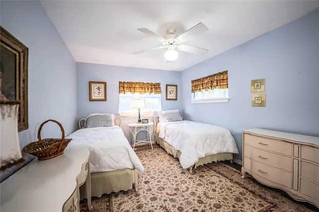 a bedroom with two beds and painting on the wall