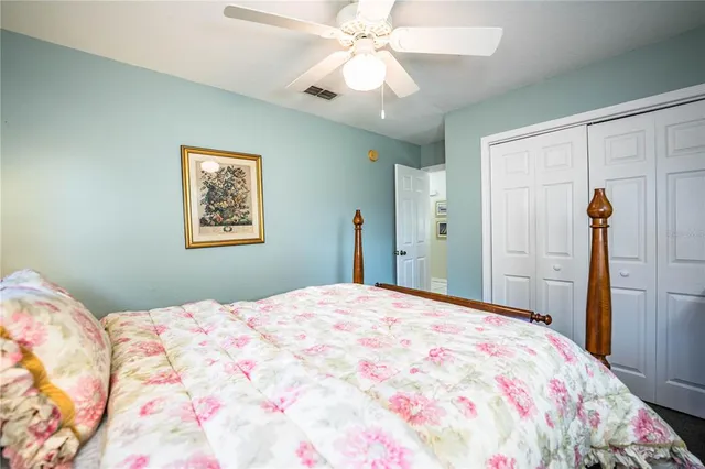 a bedroom with a large bed and a chandelier