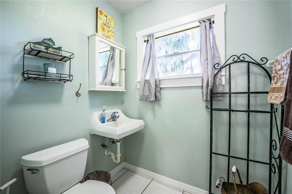1702 North Scenic Highway Babson Park, FL 33827 - Photo 32 of 46 a bathroom with a sink toilet and mirror