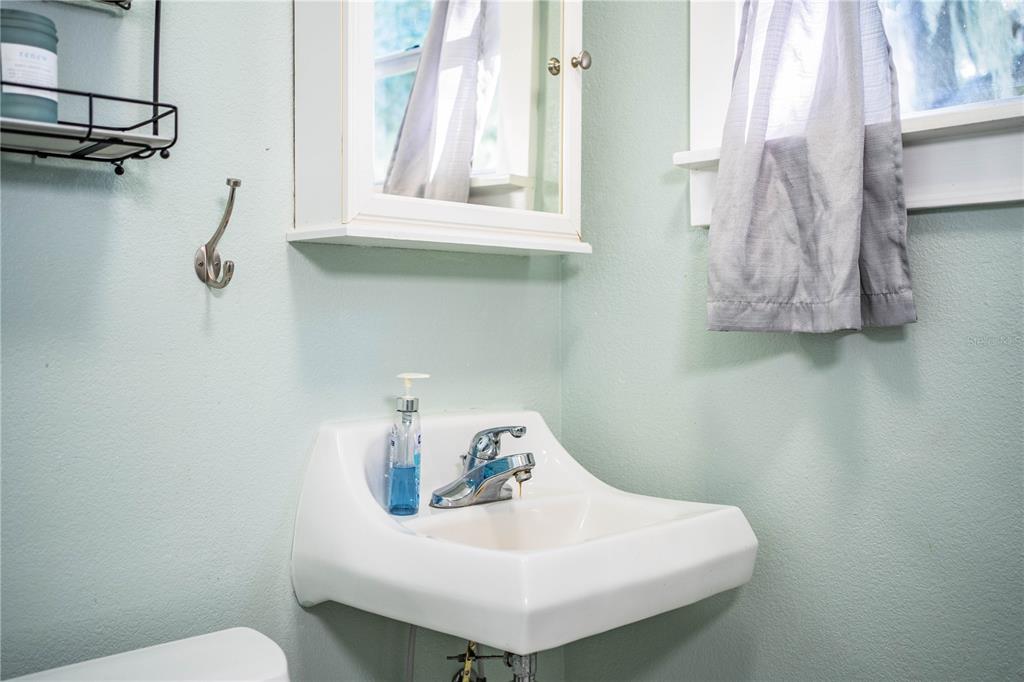 1702 North Scenic Highway Babson Park, FL 33827 - Photo 34 of 46 a bathroom with a sink a toilet and a window